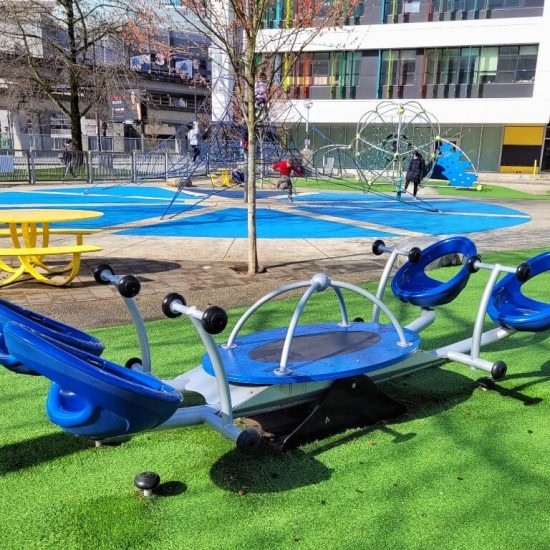 Rocker and picnic table at Crosstown elementary playground