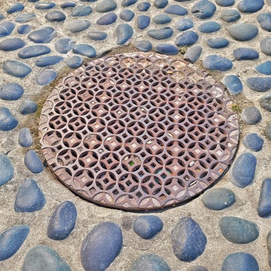 Sewer cover at Hillcrest Riley park preschool playground